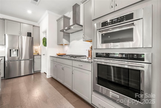 1240 Pebble Grove Dr, Clover, SC 29710 - kitchen featuring stainless steel appliances, wall chimney exhaust hood, gray cabinetry, ornamental molding, and light stone countertops