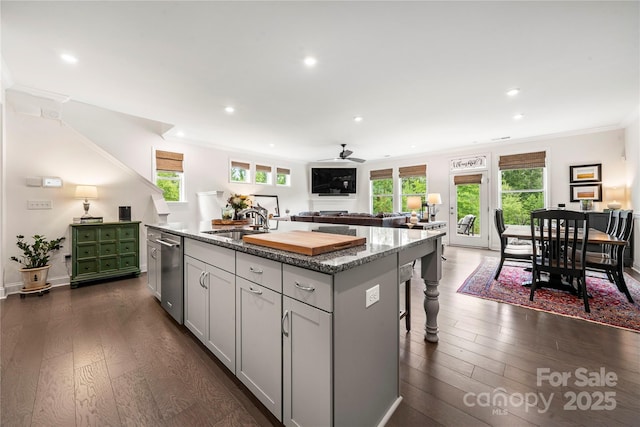 1240 Pebble Grove Dr, Clover, SC 29710 - kitchen with a center island with sink, dishwasher, crown molding, a ceiling fan, and stone countertops