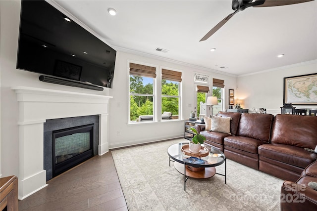 1240 Pebble Grove Dr, Clover, SC 29710 - living room featuring ceiling fan, ornamental molding, hardwood / wood-style flooring, a glass covered fireplace, and recessed lighting