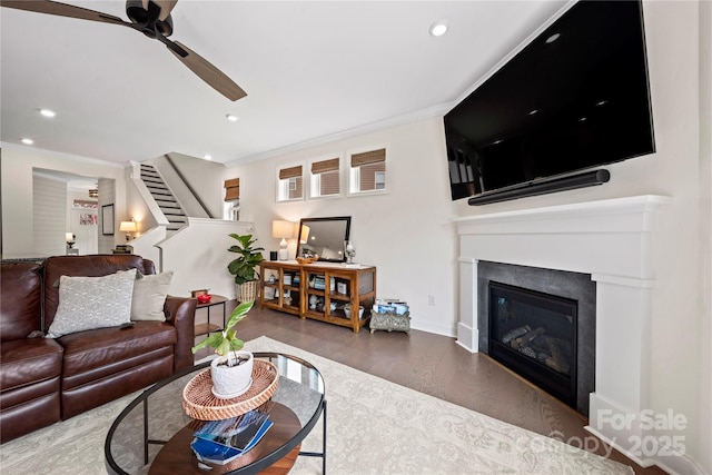1240 Pebble Grove Dr, Clover, SC 29710 - living room featuring a ceiling fan, stairway, crown molding, wood finished floors, and a glass covered fireplace