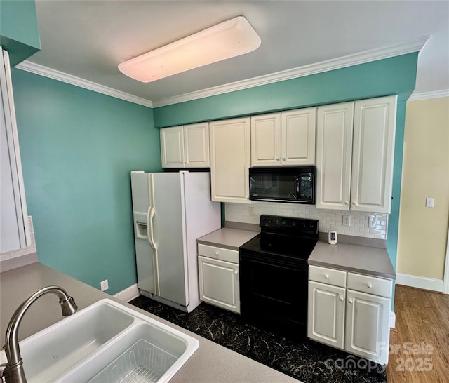 75 Mccurdy St NW, Concord, NC 28027 - kitchen featuring black appliances, white cabinets, ornamental molding, decorative backsplash, and light countertops