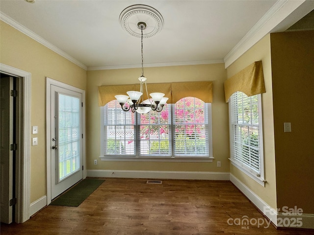 75 Mccurdy St NW, Concord, NC 28027 - unfurnished dining area featuring wood finished floors, a chandelier, and ornamental molding