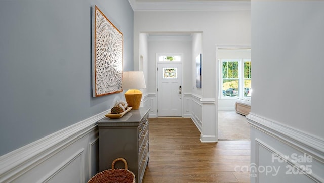4129 Duplin Dr, Charlotte, NC 28214 - foyer featuring ornamental molding, dark wood-type flooring, a wainscoted wall, and a decorative wall