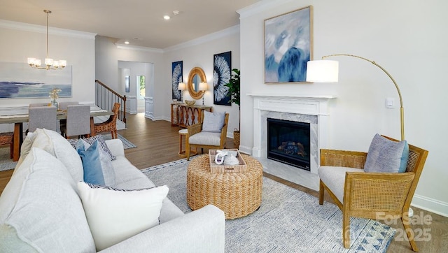4129 Duplin Dr, Charlotte, NC 28214 - living area featuring a chandelier, crown molding, wood finished floors, a fireplace, and recessed lighting