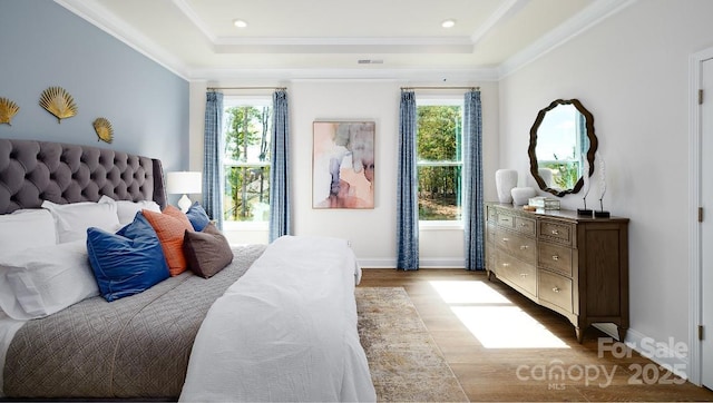 4129 Duplin Dr, Charlotte, NC 28214 - bedroom featuring wood finished floors, a raised ceiling, ornamental molding, and recessed lighting