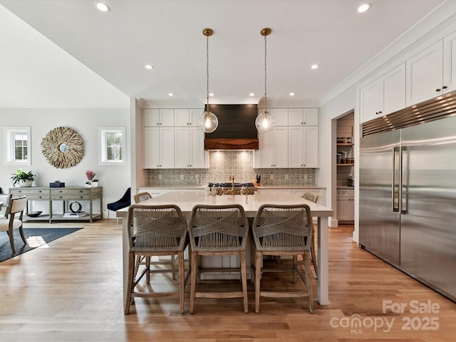 615 Melbourne Ct, Charlotte, NC 28209 - kitchen featuring stainless steel built in refrigerator, premium range hood, light countertops, backsplash, and healthy amount of natural light