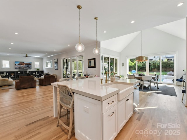 615 Melbourne Ct, Charlotte, NC 28209 - kitchen with open floor plan, recessed lighting, light wood finished floors, white cabinetry, and light countertops