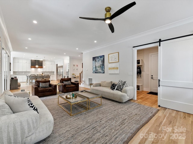 615 Melbourne Ct, Charlotte, NC 28209 - living room with ornamental molding, a barn door, a ceiling fan, recessed lighting, and light wood finished floors