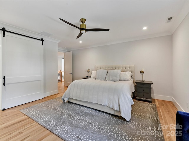 615 Melbourne Ct, Charlotte, NC 28209 - bedroom with a barn door, wood finished floors, crown molding, recessed lighting, and a ceiling fan