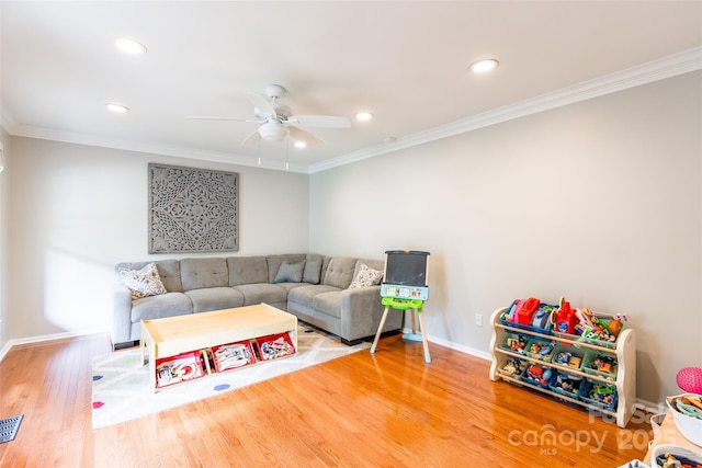 1220 Merribrook Dr, Matthews, NC 28105 - living room featuring wood finished floors, a ceiling fan, recessed lighting, and ornamental molding