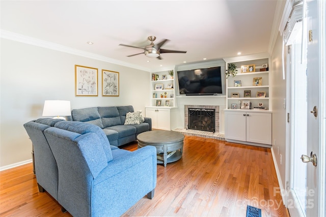 1220 Merribrook Dr, Matthews, NC 28105 - living room with a ceiling fan, a fireplace, light wood-style flooring, ornamental molding, and recessed lighting