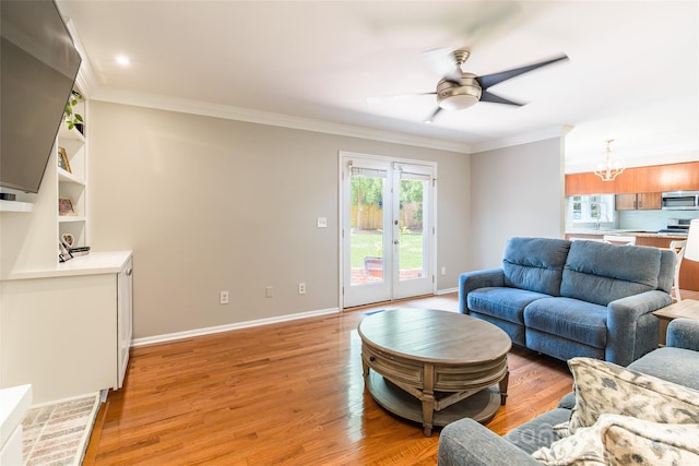 1220 Merribrook Dr, Matthews, NC 28105 - living area featuring a chandelier, crown molding, ceiling fan, and light wood-style floors