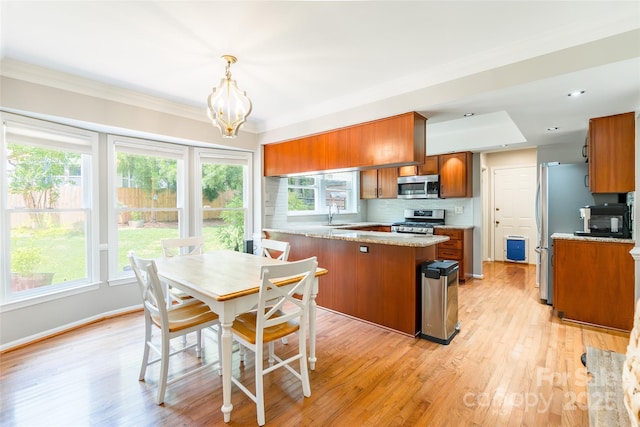 1220 Merribrook Dr, Matthews, NC 28105 - dining area featuring a chandelier, light wood-style flooring, healthy amount of natural light, and ornamental molding