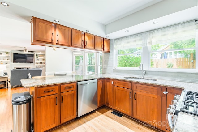 1220 Merribrook Dr, Matthews, NC 28105 - kitchen with appliances with stainless steel finishes, light wood-style floors, brown cabinetry, light stone countertops, and recessed lighting