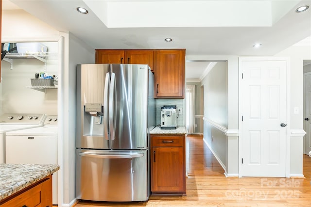 1220 Merribrook Dr, Matthews, NC 28105 - kitchen featuring stainless steel refrigerator with ice dispenser, washing machine and clothes dryer, brown cabinets, recessed lighting, and crown molding