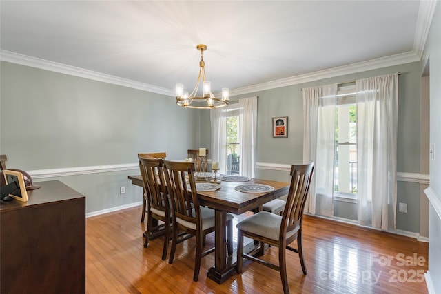 1220 Merribrook Dr, Matthews, NC 28105 - dining space featuring a chandelier, ornamental molding, and hardwood / wood-style flooring