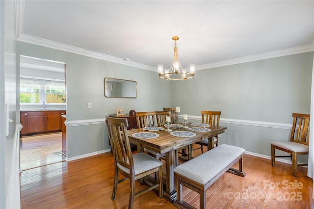 1220 Merribrook Dr, Matthews, NC 28105 - dining space with a chandelier, light wood-style flooring, and crown molding