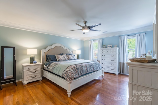 1220 Merribrook Dr, Matthews, NC 28105 - bedroom with ornamental molding, wood finished floors, and a ceiling fan