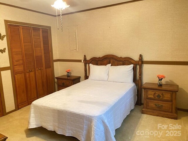 268 Poor Boy Ln, Whittier, NC 28789 - bedroom with light colored carpet, a closet, ornamental molding, and wallpapered walls