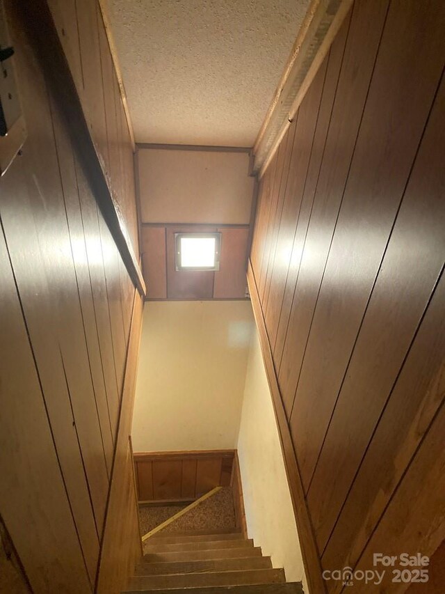 268 Poor Boy Ln, Whittier, NC 28789 - stairs featuring a textured ceiling and wood walls