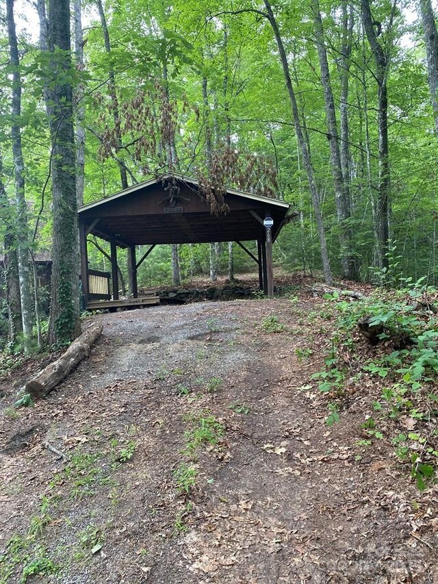 268 Poor Boy Ln, Whittier, NC 28789 - view of yard featuring dirt driveway, a forest view, and a carport