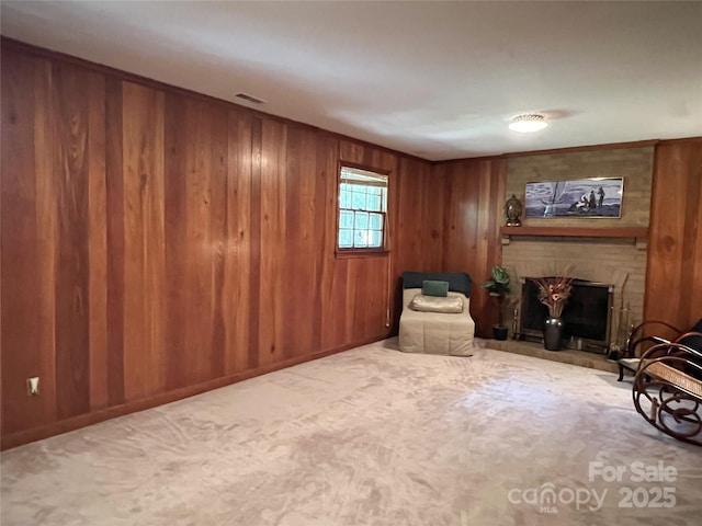 5938 Sharon Rd, Charlotte, NC 28210 - sitting room featuring a fireplace, wood walls, and carpet