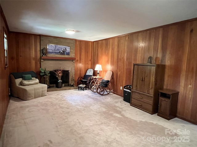 5938 Sharon Rd, Charlotte, NC 28210 - living area featuring wooden walls, a fireplace, and light colored carpet