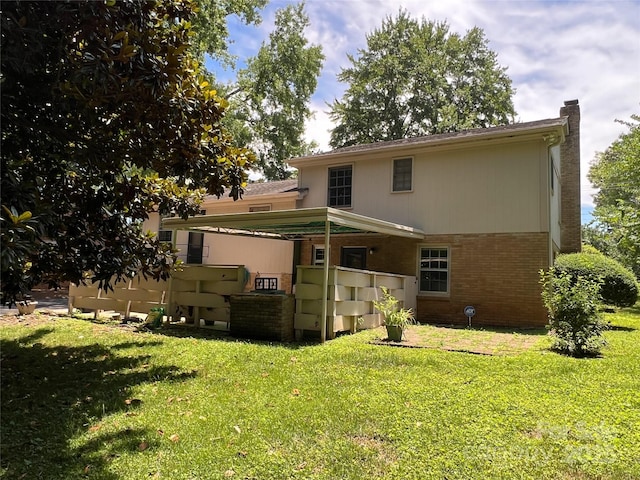 5938 Sharon Rd, Charlotte, NC 28210 - back of property featuring a lawn, a chimney, and brick siding