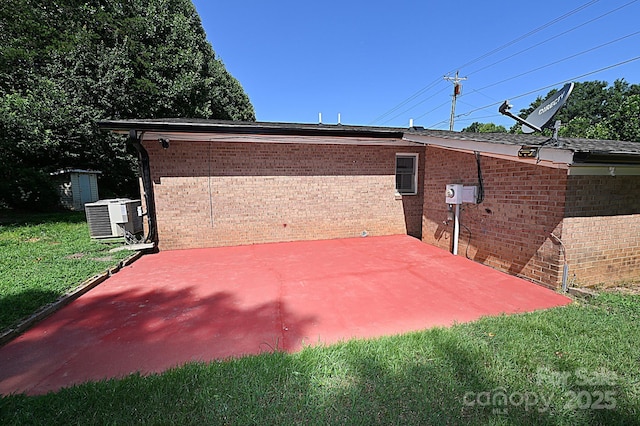 112 Lovelady Rd, Valdese, NC 28690 - view of home's exterior featuring a patio area, brick siding, a lawn, and a shed