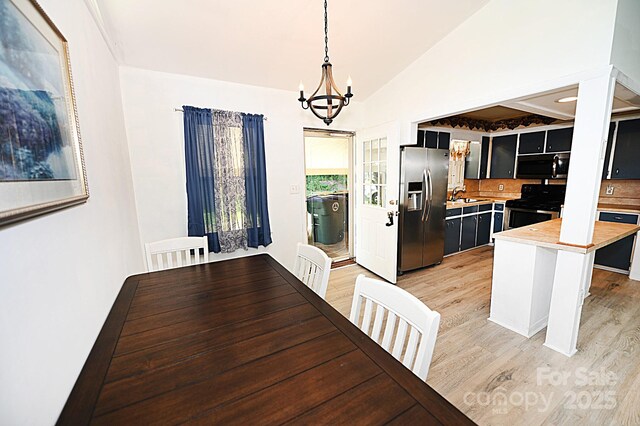 112 Lovelady Rd, Valdese, NC 28690 - unfurnished dining area with a chandelier, light wood finished floors, and vaulted ceiling