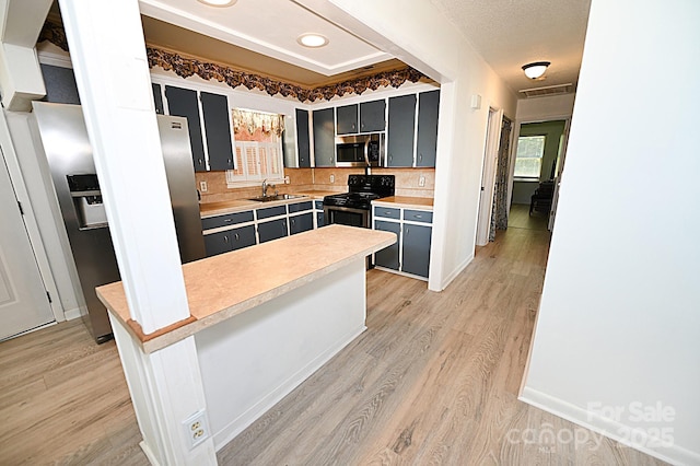 112 Lovelady Rd, Valdese, NC 28690 - kitchen featuring appliances with stainless steel finishes, light countertops, light wood finished floors, and dark cabinets