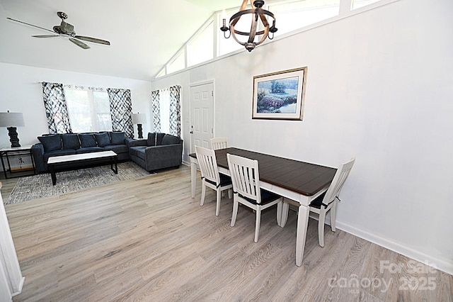 112 Lovelady Rd, Valdese, NC 28690 - dining area featuring light wood-type flooring, ceiling fan, high vaulted ceiling, and a chandelier