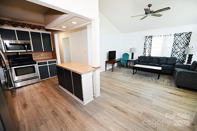 112 Lovelady Rd, Valdese, NC 28690 - kitchen featuring stainless steel appliances, dark cabinetry, light wood-style floors, a ceiling fan, and vaulted ceiling