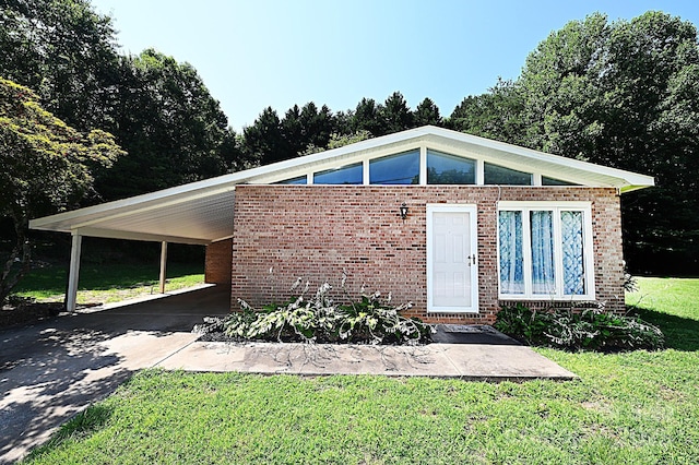 112 Lovelady Rd, Valdese, NC 28690 - view of front of house with concrete driveway, an attached carport, a front yard, and brick siding