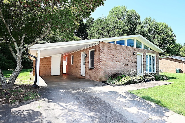 112 Lovelady Rd, Valdese, NC 28690 - view of front of house featuring brick siding, driveway, an attached carport, and a front lawn
