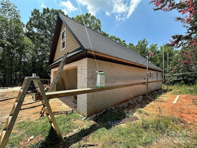 1500 Crowders Creek Rd, Gastonia, NC 28052 - view of side of property with brick siding, a shingled roof, and a garage
