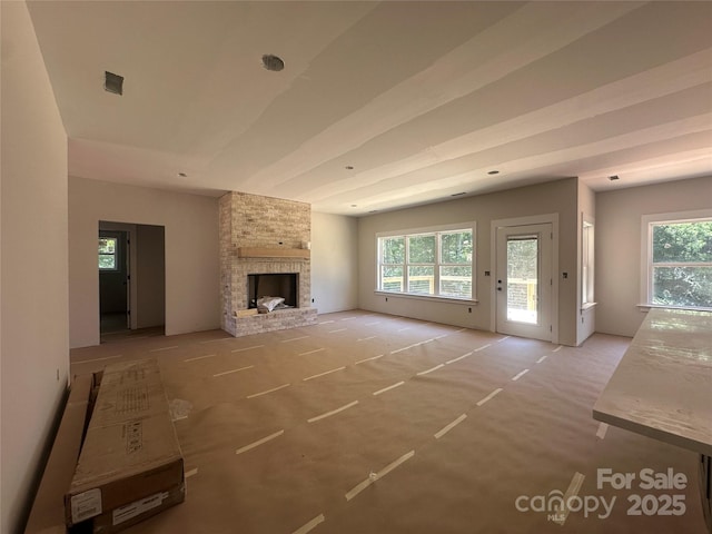 1500 Crowders Creek Rd, Gastonia, NC 28052 - unfurnished living room featuring plenty of natural light, light colored carpet, and a fireplace