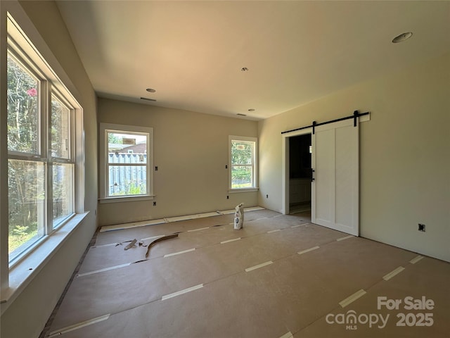 1500 Crowders Creek Rd, Gastonia, NC 28052 - unfurnished bedroom with a barn door and recessed lighting