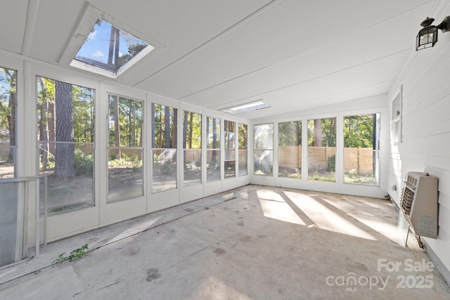 4918 Tyne Dr, Durham, NC 27703 - unfurnished sunroom with a skylight, healthy amount of natural light, heating unit, and lofted ceiling