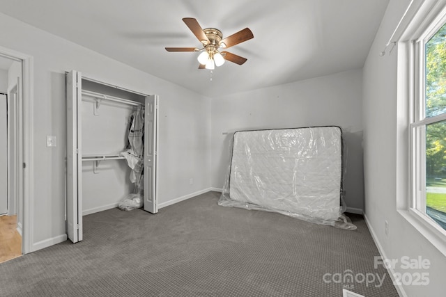 4918 Tyne Dr, Durham, NC 27703 - unfurnished bedroom featuring carpet, a closet, and a ceiling fan