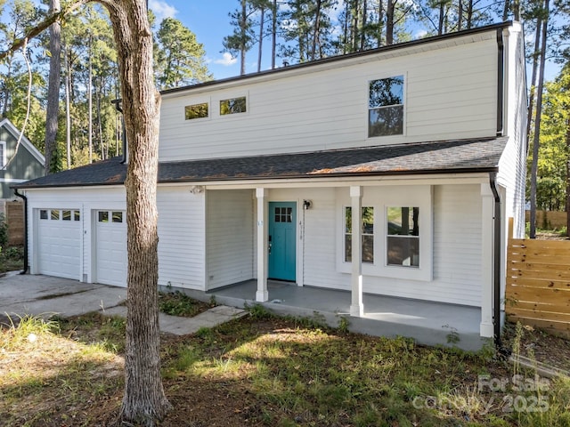 4918 Tyne Dr, Durham, NC 27703 - view of front of house with covered porch, concrete driveway, and a garage