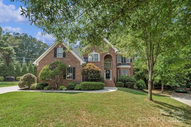 8606 Gresham Dr, Waxhaw, NC 28173 - traditional home with brick siding and a front lawn