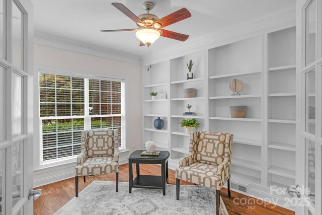 8606 Gresham Dr, Waxhaw, NC 28173 - living area with crown molding, a ceiling fan, wood finished floors, and built in features