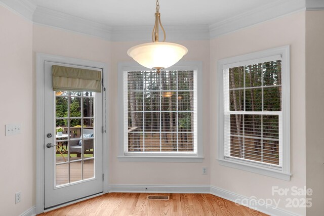 8606 Gresham Dr, Waxhaw, NC 28173 - unfurnished dining area with wood finished floors and crown molding