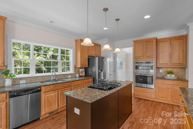 8606 Gresham Dr, Waxhaw, NC 28173 - kitchen with stainless steel appliances, ornamental molding, light wood-type flooring, a kitchen island, and dark stone counters