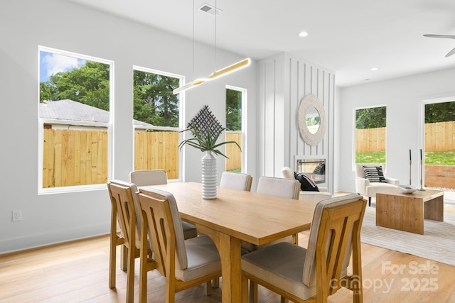 2417 Pruitt St, Charlotte, NC 28208 - dining space featuring healthy amount of natural light, light wood finished floors, a multi sided fireplace, and recessed lighting