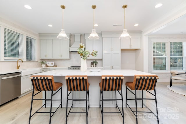 4114 Mantle Ct, Charlotte, NC 28205 - kitchen with stainless steel dishwasher, custom range hood, a kitchen island, white cabinets, and light wood finished floors