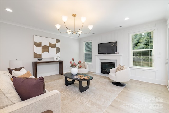 4114 Mantle Ct, Charlotte, NC 28205 - living room with wood finished floors, crown molding, a high end fireplace, a chandelier, and recessed lighting