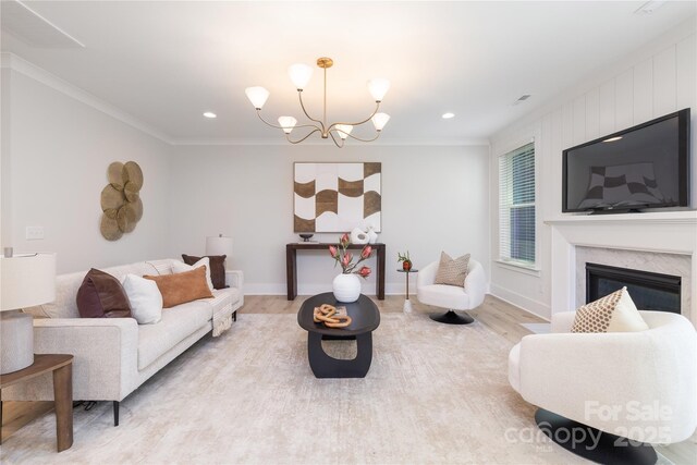 4114 Mantle Ct, Charlotte, NC 28205 - living room with light wood-style floors, ornamental molding, a chandelier, a premium fireplace, and recessed lighting
