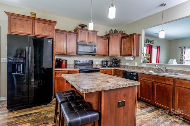 127 Tranquil Ct Unit 18A, Locust, NC 28097 - kitchen featuring black appliances, dark wood-style floors, a center island, and decorative light fixtures